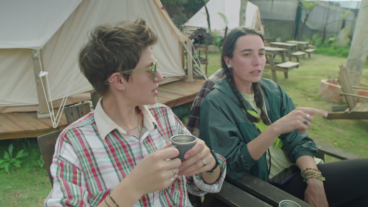 Two Female Friends Resting at Glamping and Talking over Tea