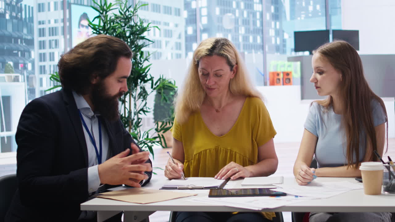 asesor financiero que invita a los clientes a firmar documentos formales de acuerdo