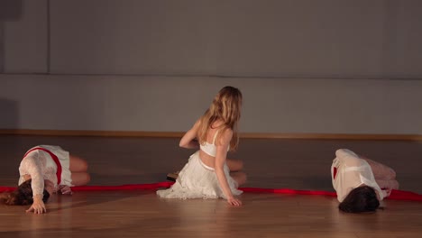 contemporary dance performance with red ribbons