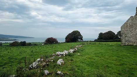 The-rustic-ruins-of-Capel-Lligwy-on-rural-Moelfre-countryside,-Anglesey,-North-Wales