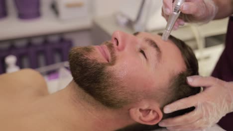 man receiving facial treatment
