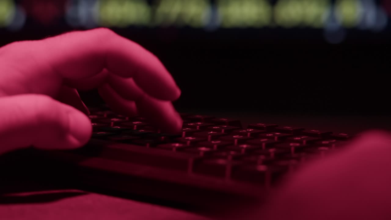 Hands Typing on a Keyboard at Night