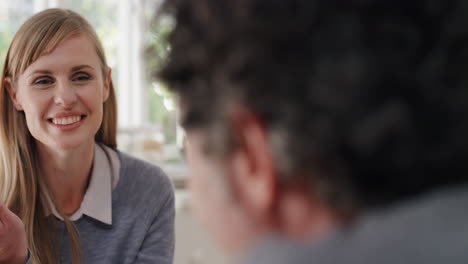 happy-young-couple-eating-breakfast-together-beautiful-woman-sitting-with-husband-at-table-sharing-morning-meal-in-kitchen-chatting-with-partner-day-in-the-life-4k-footage