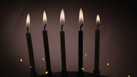 confeti dorado cayendo sobre la silueta de varias velas encendidas contra un fondo gris