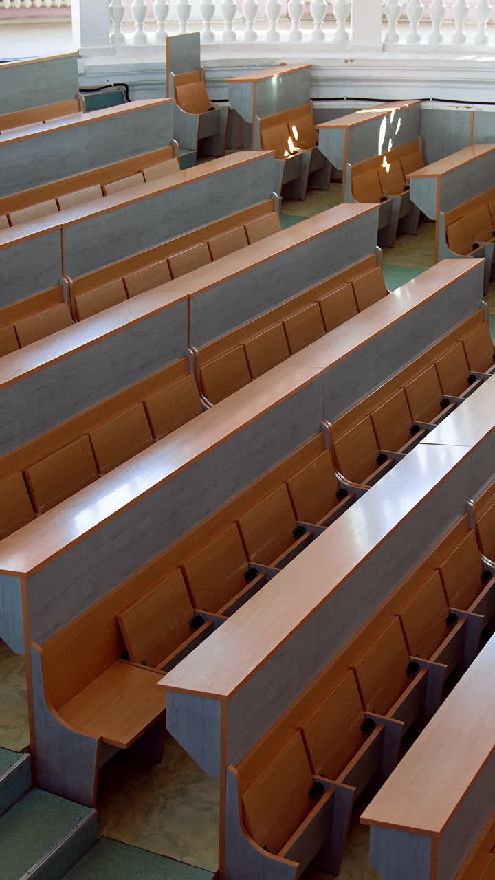 Shot of empty university classroom. Empty modern lecture style university classroom. Vertical video