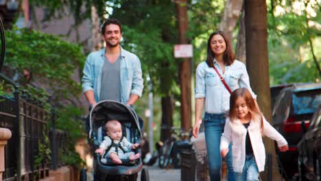 happy young family walking in a brooklyn street