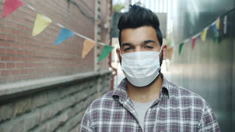 man wearing mask in urban alley