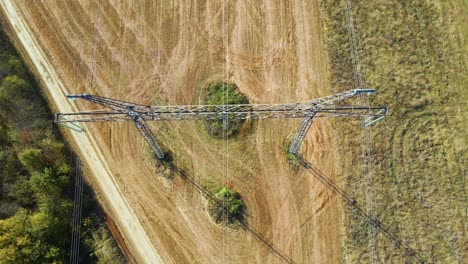 high voltage tower with electric power lines transfening electrical energy through cable wires