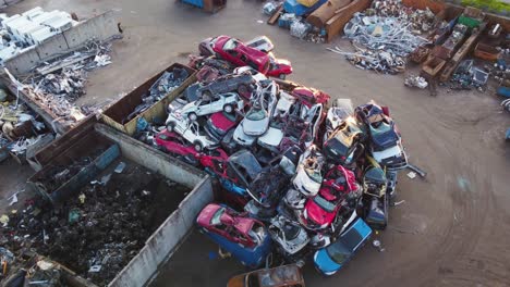 pile of demolished cars at a scrapyard