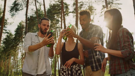 playful friends clinking glasses outdoors