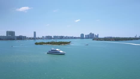 beautiful aerial shot over yacht in the middle of water in miami beach