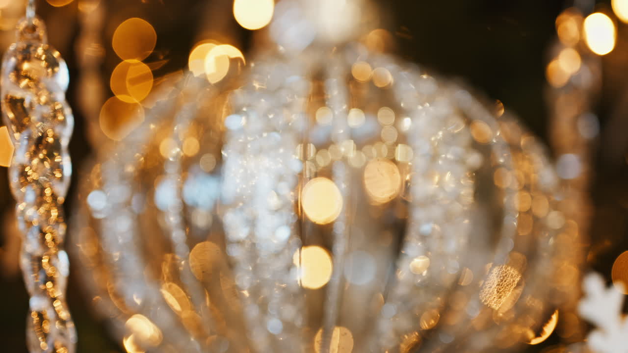 Close up of a globe decoration on a lighted Christmas tree