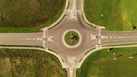 cars on road intersection roundabout, top view drone pov