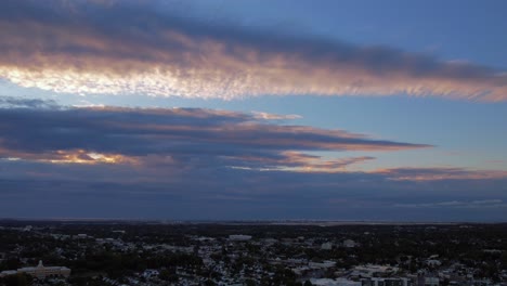 a high angle, time lapse over a residential neighborhood on long island, ny on a cloudy morning