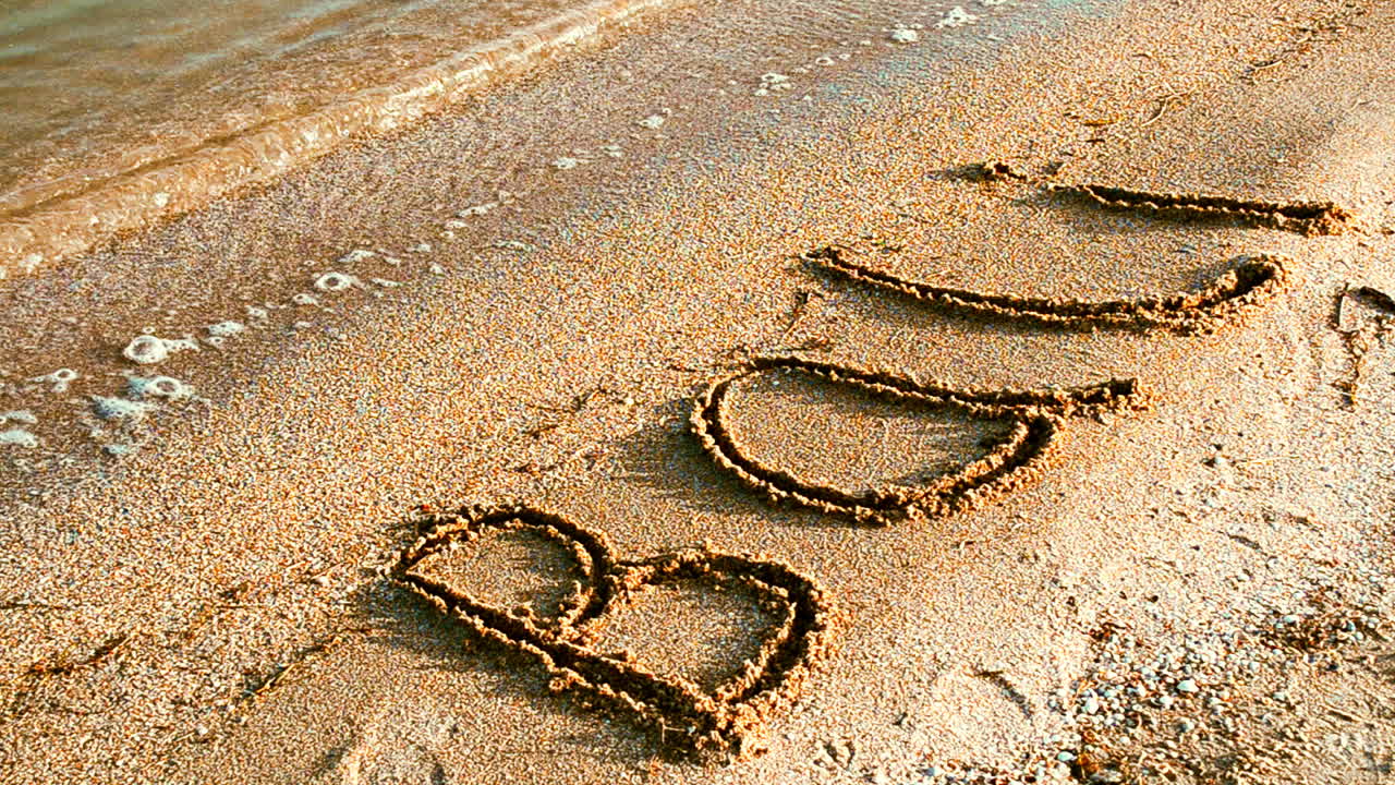 Inscription Bali on sandy beach. Inscription on sand, the beach