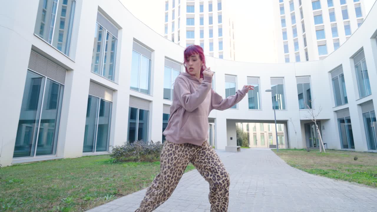 Young urban dancer performing energetic freestyle moves outdoors