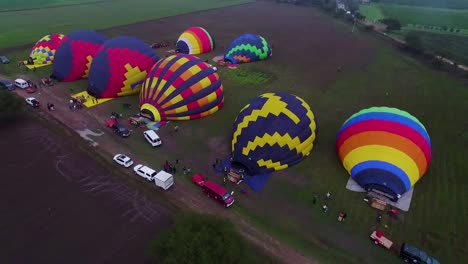 hot air balloons being inflated for a flight.