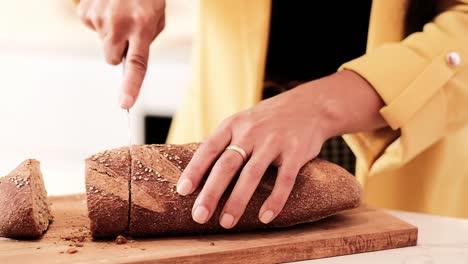 crop woman cutting bread in kitchen