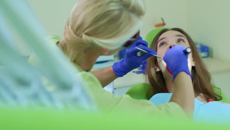 Dentista-Trabajando-Con-Lámpara-De-Polimerización-Dental-En-La-Cavidad-Bucal.-Alta-Tecnología