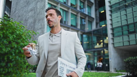 eating man hurrying business district. formal suit leader taking lunch on go