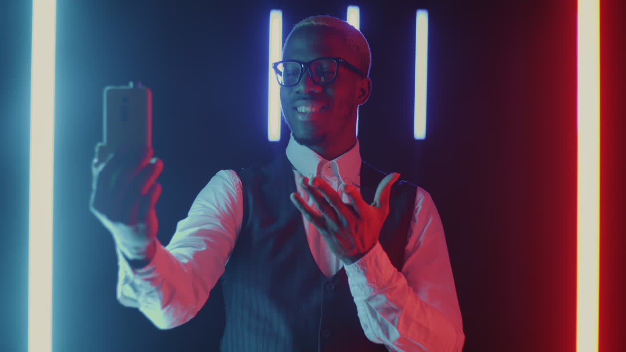 Man Taking a Selfie in Neon Lighting