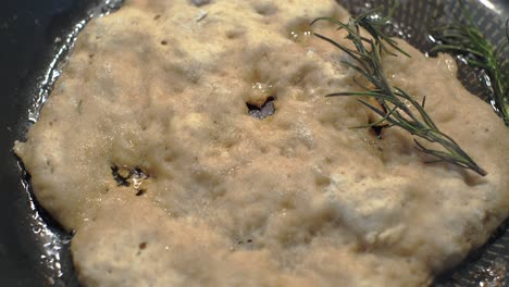 close-up. cooking homemade tortillas in a pan. adding a rosemary sprig