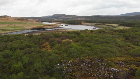 aerial recording over the forests located near the glanni waterfall in iceland