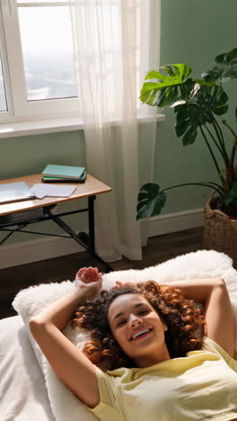 young woman relaxing happily in a bright room