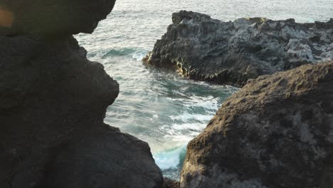 ocean waves crash against rocky rugged beach in los gigantes, tenerife