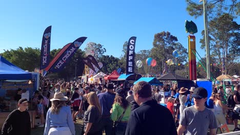 crowded festival with music, food, and colorful banners