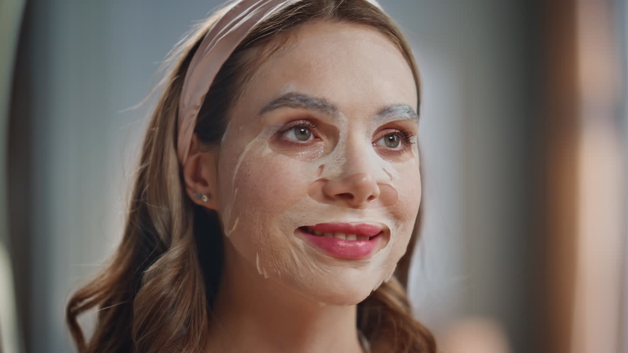 Woman applying a hydrating face mask for skincare