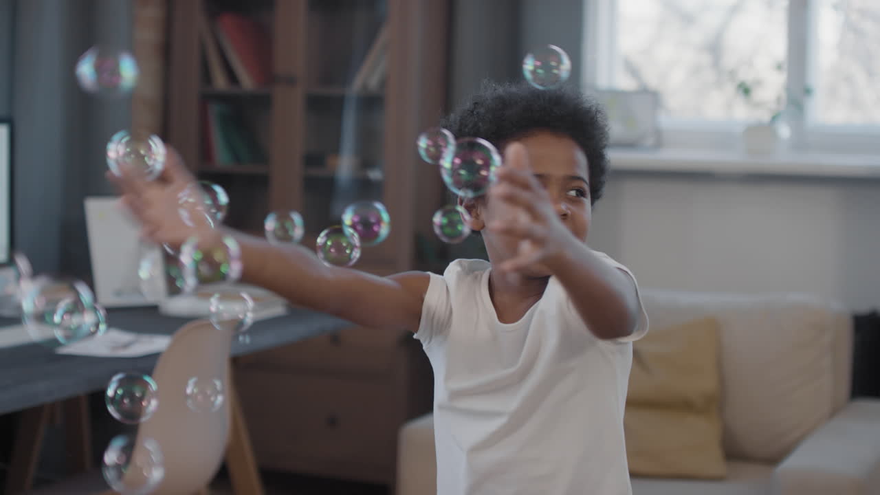 Mixed-Race Siblings Playing With Soap Bubbles