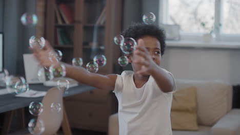 Mixed-Race Siblings Playing With Soap Bubbles