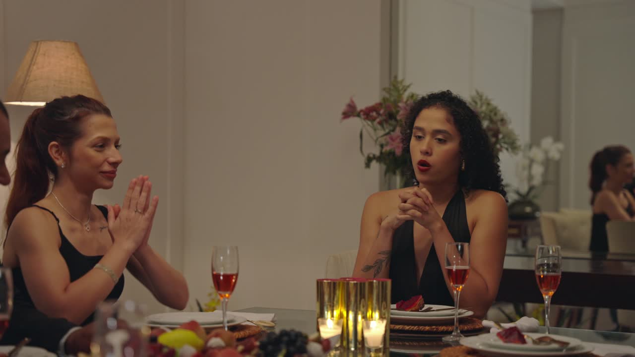 People enjoying a lively dinner party with conversation and laughter