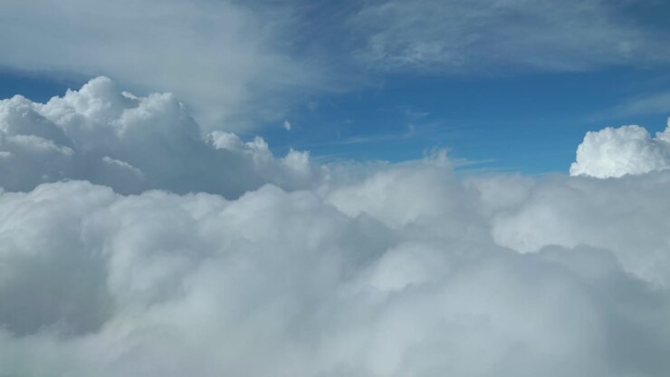 Airplane flying in to the clouds view from cockpit