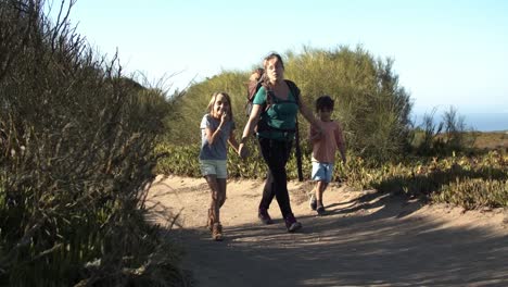 happy kids and mom wearing backpack