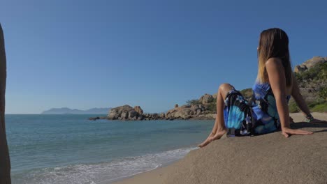 caucasian tourist relaxing on the beach of horseshoe bay in bowen, queensland, australia