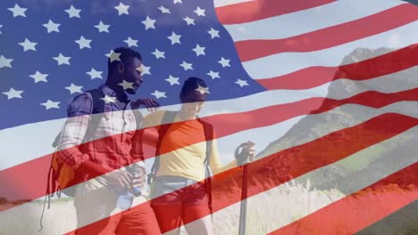 Animation-of-american-flag-over-diverse-couple-walking-in-mountains
