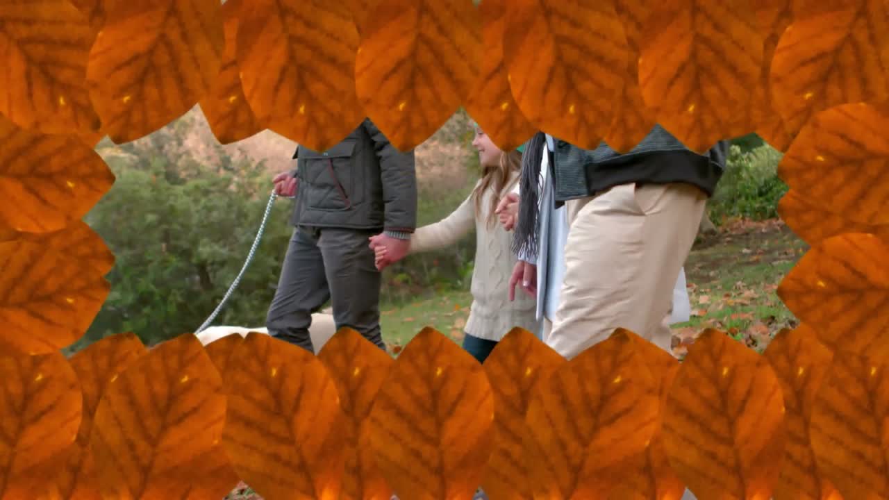 공원에서  ⁇ 고 있는 백인 가족 위에 떨어지는 가을 잎의 애니메이션