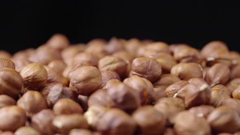 pile of hazelnuts with some falling