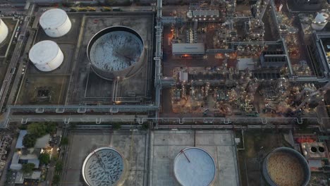 aerial view oil and gas industrial, refinery factory oil storage tank and pipeline steel at night