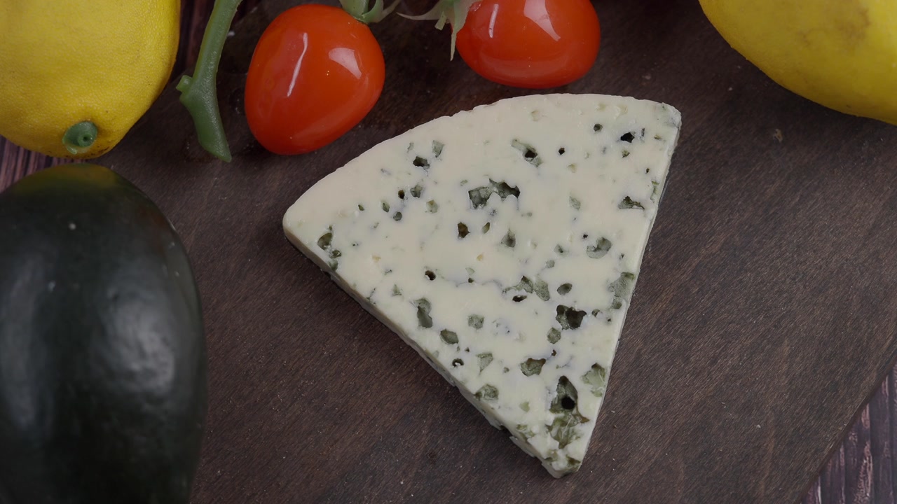 Gourmet Blue Cheese and Fresh Produce on a Rustic Cutting Board