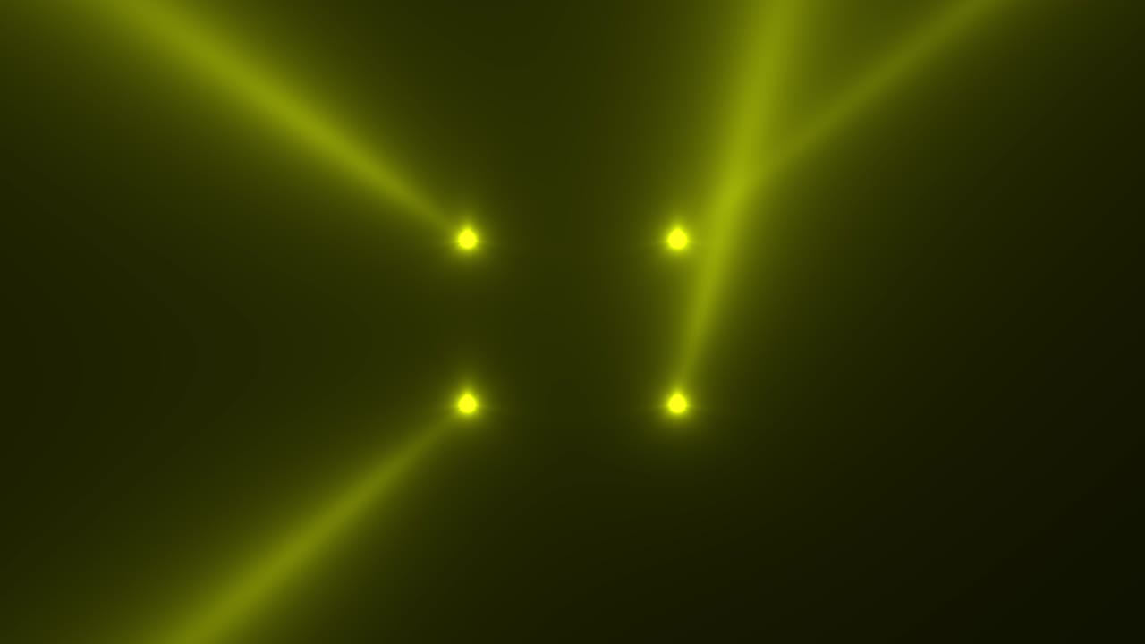 Glowing yellow spotlight beams on stage