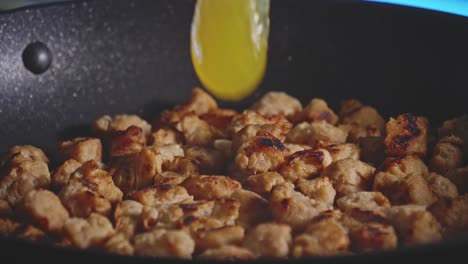 adding soy sauce and honey ingredients to fried soy and stirring while preparing sweet and sour soy