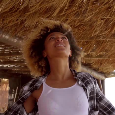 mujer joven admirando la vista al mar en un día ventoso