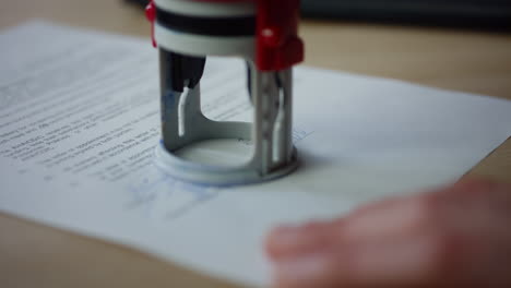 man hands signing document putting seal close up. writing signature on paper.