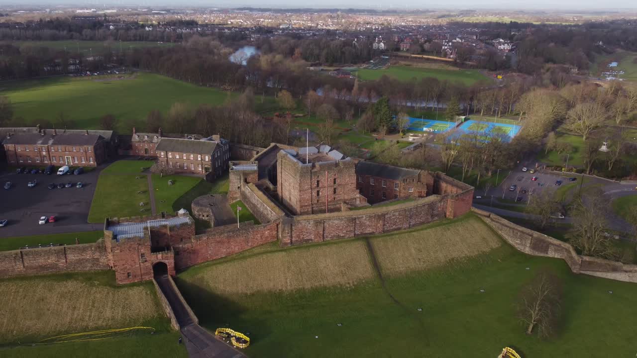 Drone revealing Carlisle Castle with Bitts Park and River Eden in background - Cumbria, England
