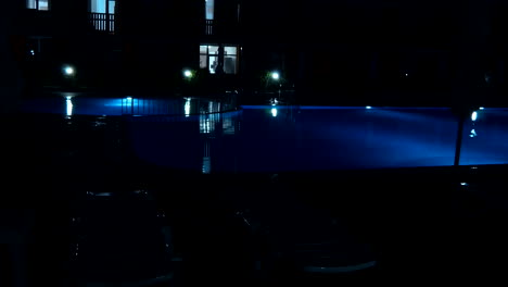 swimming pool at a luxury, tropical resort at night