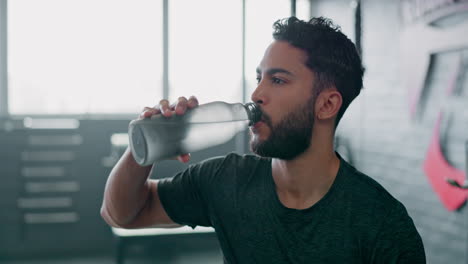 Drinking-water,-fitness-and-tired-man-in-gym