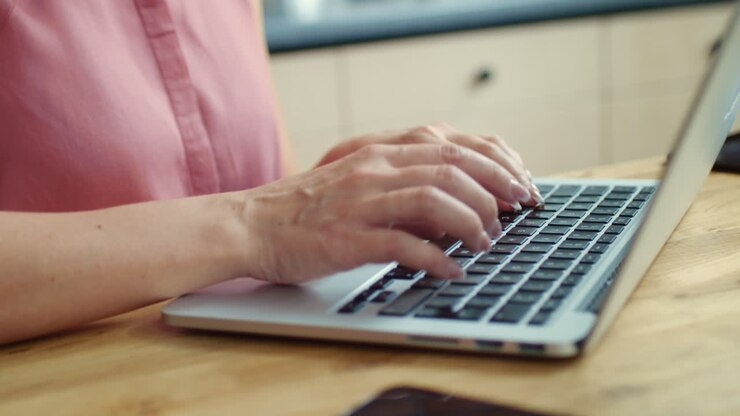 Businesswoman working on laptop at home. Housewife chatting online with friend.